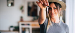 home buyer holding keys after successful real estate selling